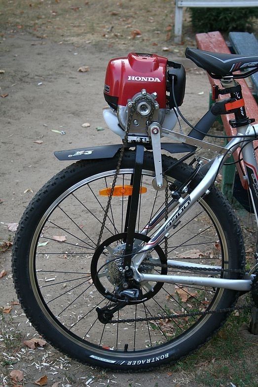 a bicycle parked next to a park bench.jpg