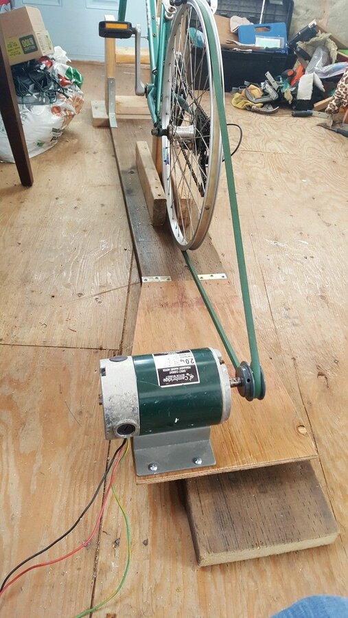 a bicycle is being worked on by someone using a power drill to fix the wheel.jpg